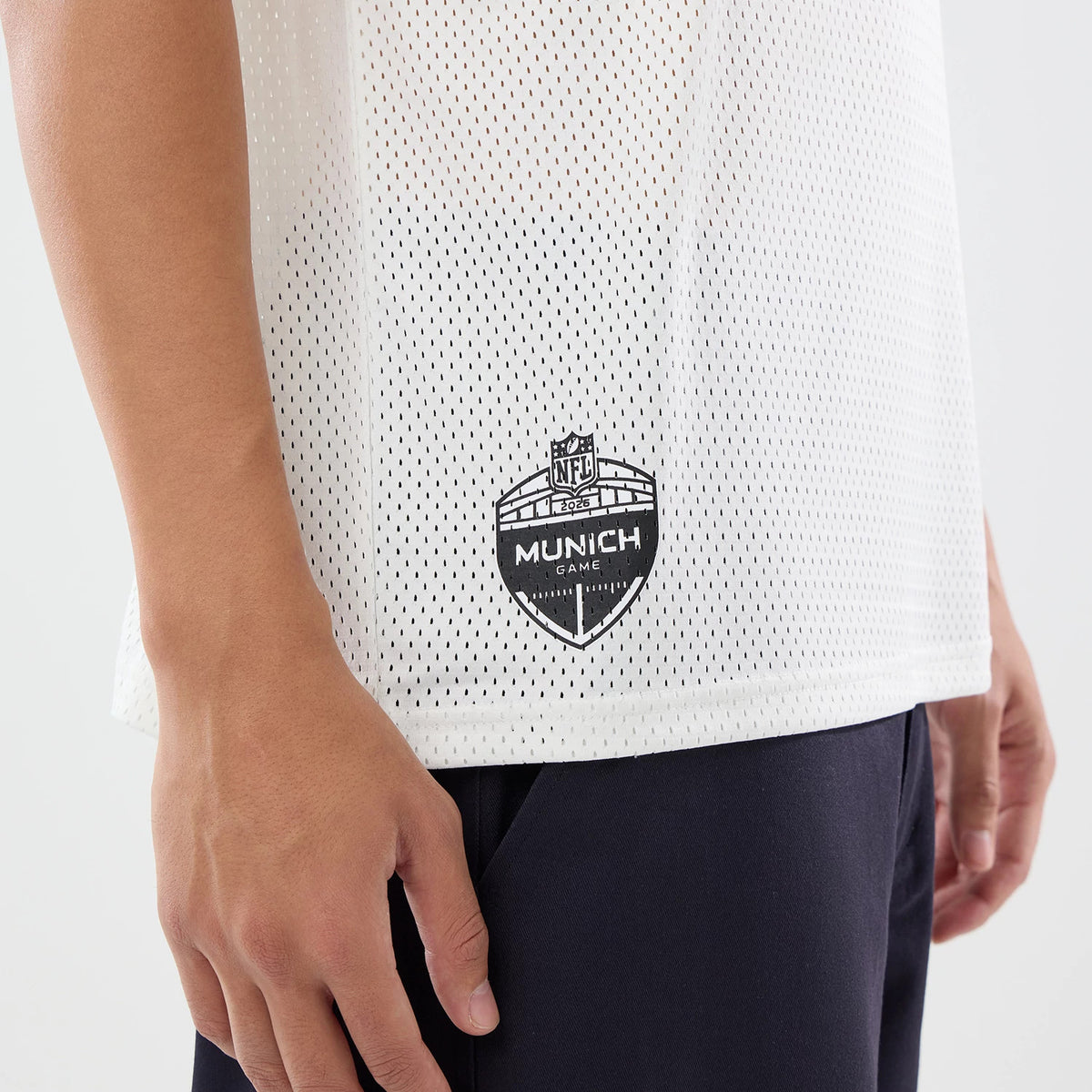 The model is wearing this NFL International Games 2026 New England Patriots Mesh Jersey in white. 4