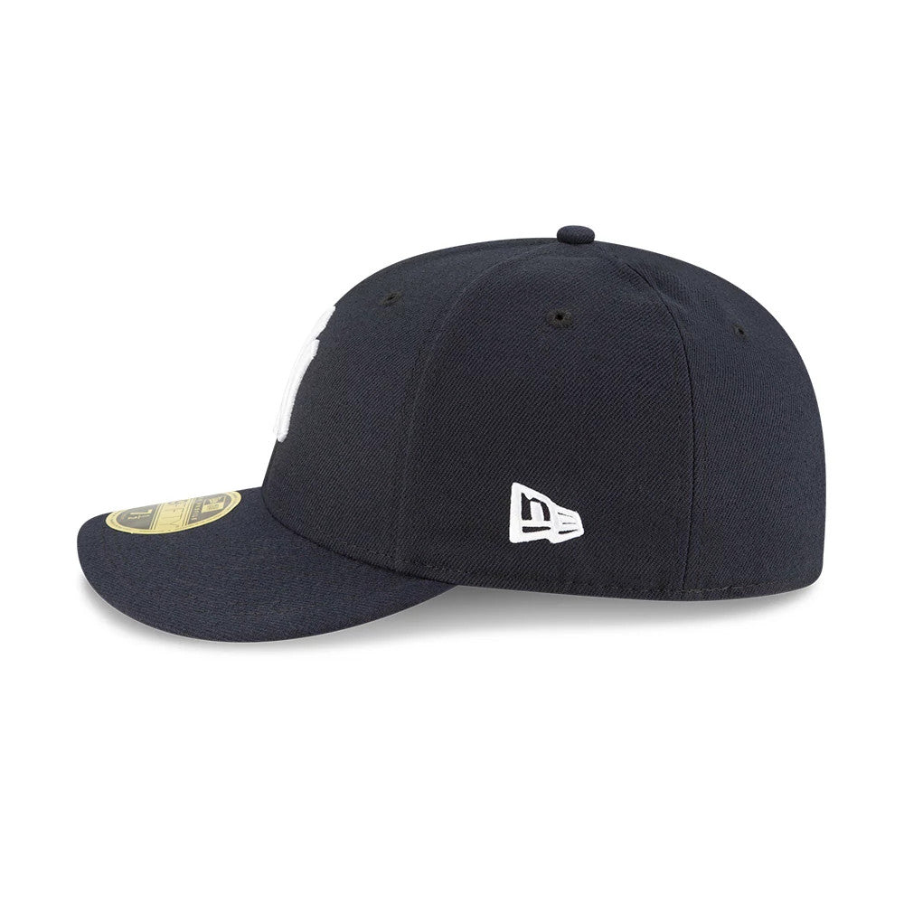 New York Yankees AC Perf Navy New Era 59FIFTY Low Profile Cap, side view showing the white New Era flag logo embroidered on the left side, a structured navy crown with eyelets, and the gold 59FIFTY size sticker on the curved visor.
