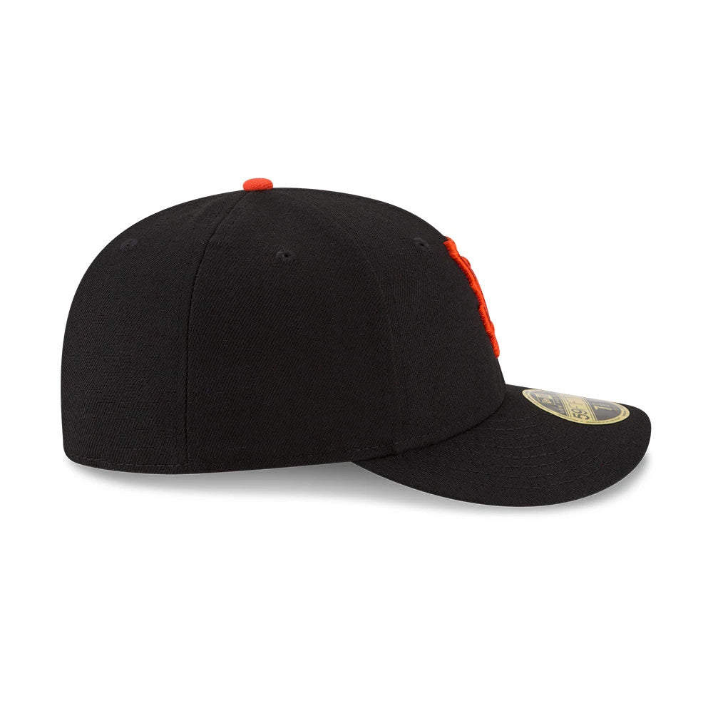 San Francisco Giants Authentic Collection Low Profile New Era 59FIFTY, side view showing the structured black crown with orange embroidered eyelets, a gold 59FIFTY size sticker on the flat black visor, and the top button in matching orange.