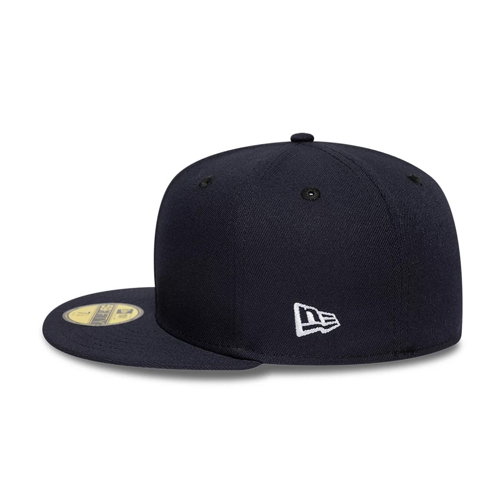 New Era Navy 59FIFTY Fitted Cap, three-quarter view showing the white embroidered New Era flag logo on the left side, a gold 59FIFTY size sticker on the navy flat visor, and the structured navy crown with black eyelets.