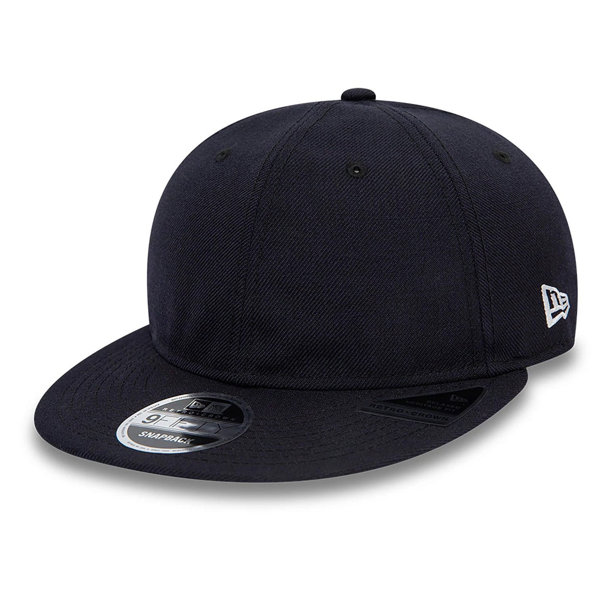 Blank New Era Navy Retro Crown 9FIFTY Snapback Cap, three-quarter view showing the navy structured crown, black flat visor with a 9FIFTY size sticker, and the white New Era flag logo embroidered on the left side.