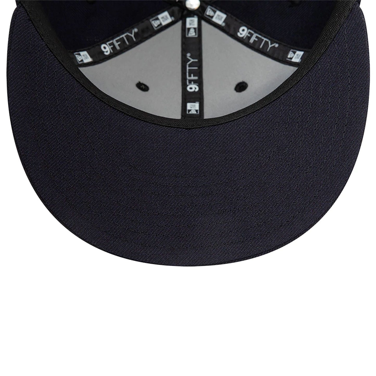 Blank New Era Navy Retro Crown 9FIFTY Snapback Cap, inside view showing the grey undervisor, black sweatband with repeated 9FIFTY branding, and the sewn-in taping intersecting at the top button inside the structured navy crown.
