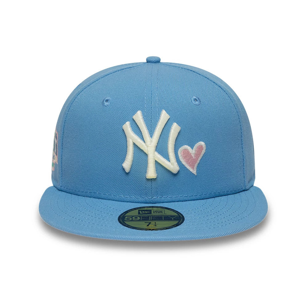 New York Yankees MLB Heart Pastel Blue New Era 59FIFTY Fitted Cap, front view showing the raised white NY logo and pink heart embroidered on the front panel, with a matching pastel blue visor and a gold 59FIFTY size sticker on the visor.