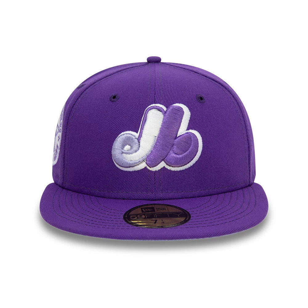 Montreal Expos All Star Game Purple New Era 59FIFTY Fitted Cap, front view showing the white and purple embroidered Expos logo on the front panel, a matching purple flat visor, and an attached gold 59FIFTY size sticker.