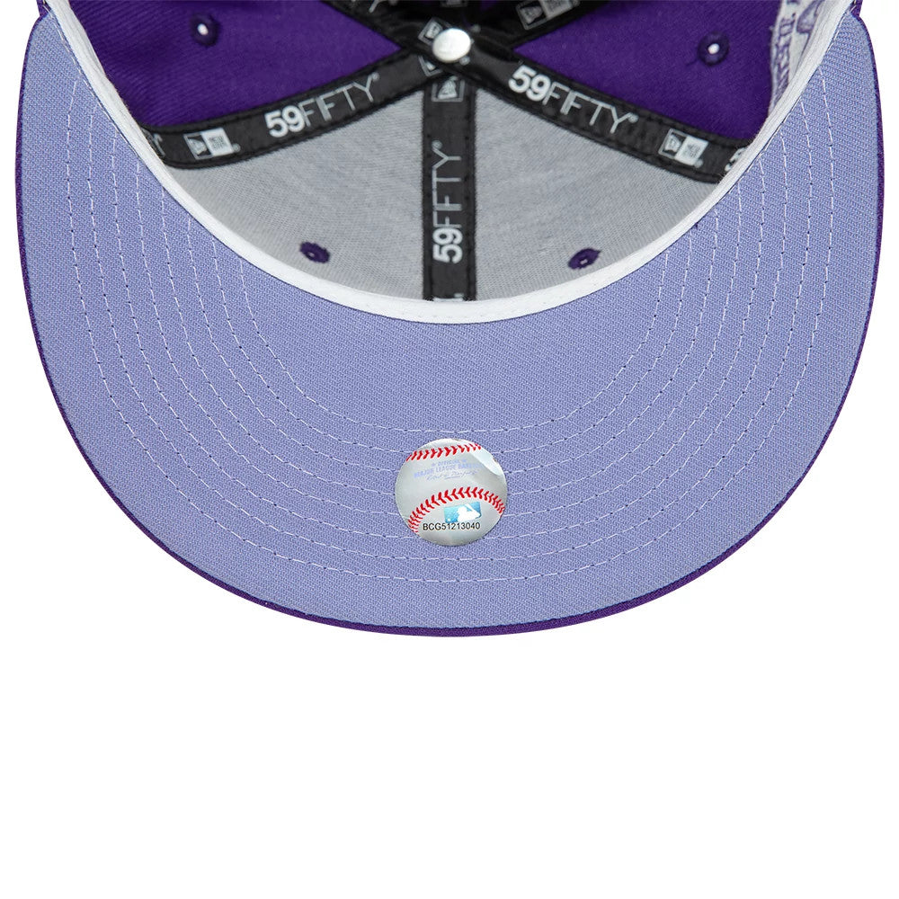 Montreal Expos All Star Game Purple New Era 59FIFTY Fitted Cap, inside view showing purple and grey interior, black 59FIFTY taping, grey undervisor with white stitching, and a baseball-themed size sticker centred on the undervisor.