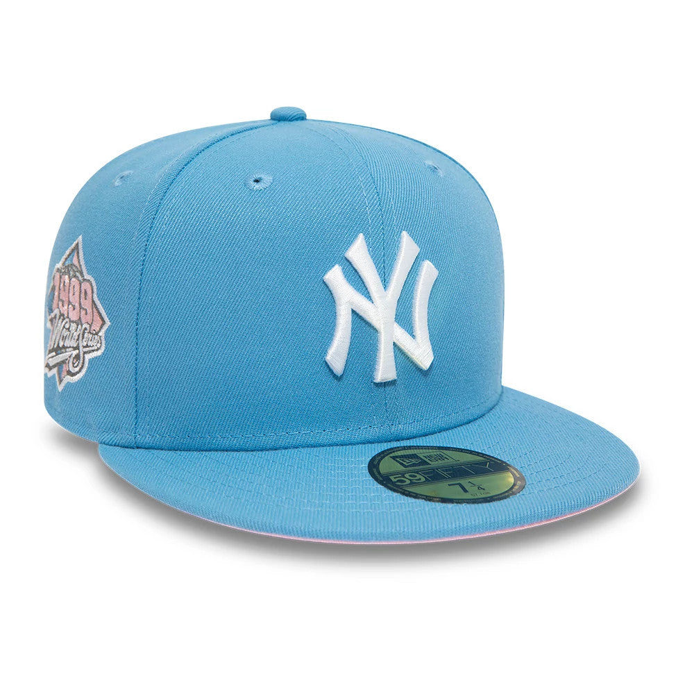 New York Yankees Pastel Blue New Era 59FIFTY Fitted Cap, three-quarter view showing the white embroidered NY logo on the front panel, the 1999 World Series patch on the right side, and a flat pastel blue visor with a gold 59FIFTY size sticker.