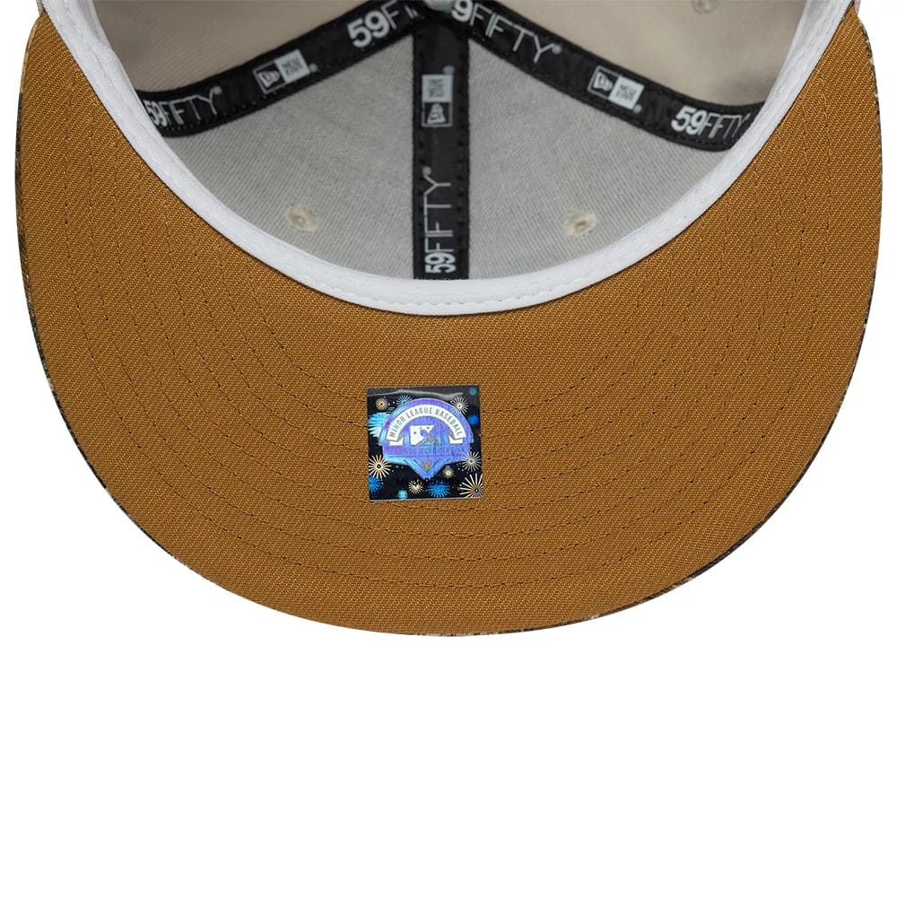 Gwinnett Stripers MiLB Hometown Beige New Era 59FIFTY Fitted Cap, inside view showing a black 59FIFTY taping across the seams, a light grey sweatband lining the inner edge, and a small holographic sticker on the underside of the brown visor.