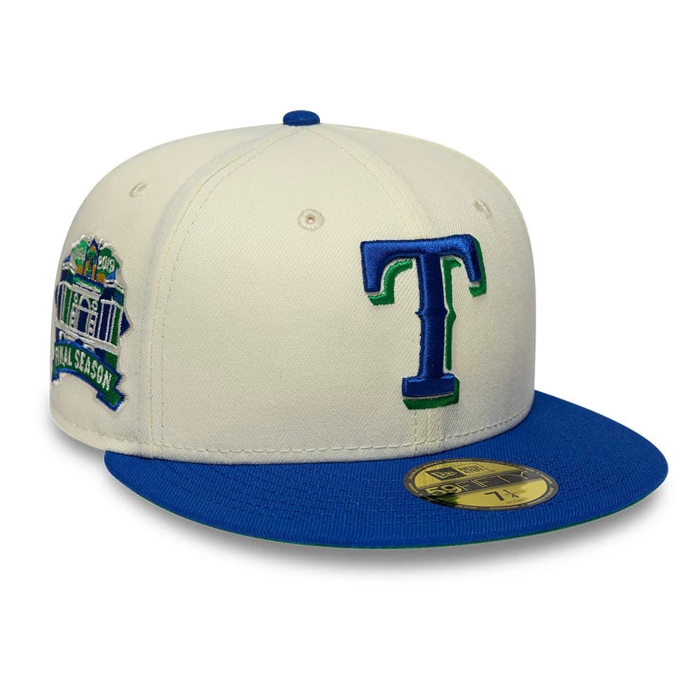 Texas Rangers MLB Cooperstown White & Blue New Era 59FIFTY Fitted Cap, three-quarter view showing a blue and green embroidered T logo on the front panel, with a blue flat visor and a gold 59FIFTY size sticker.