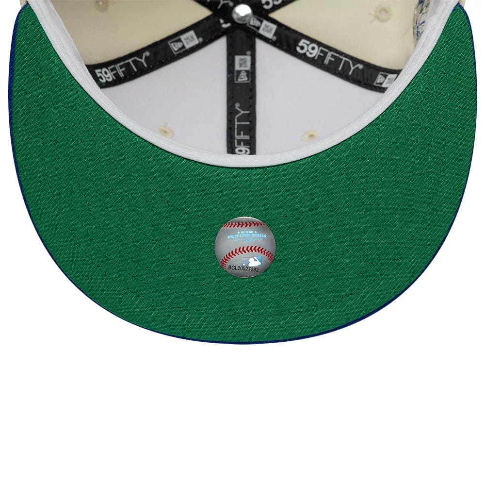 Texas Rangers MLB Cooperstown White & Blue New Era 59FIFTY Fitted Cap, inside view showing black 59FIFTY-branded taping across the cream panels, a white sweatband edge, and a green undervisor with a baseball-themed sticker at the centre.