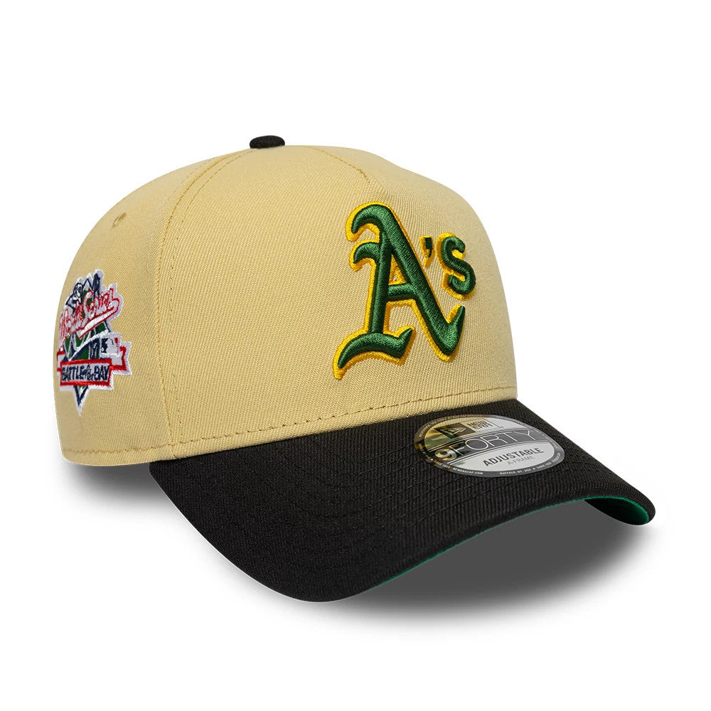 Athletics MLB Vegas Gold New Era 9FORTY A-Frame Cap, three-quarter view showing a raised green and yellow A's logo on the front panel, a contrasting black visor with a 9FORTY size sticker, and a colourful side patch on the left side.