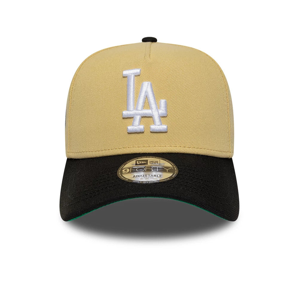 LA Dodgers MLB Vegas Gold New Era 9FORTY A-Frame Cap, front view showing the white raised embroidered LA logo on the gold structured crown, with a black curved visor featuring a 9FORTY size sticker and a contrasting green undervisor.