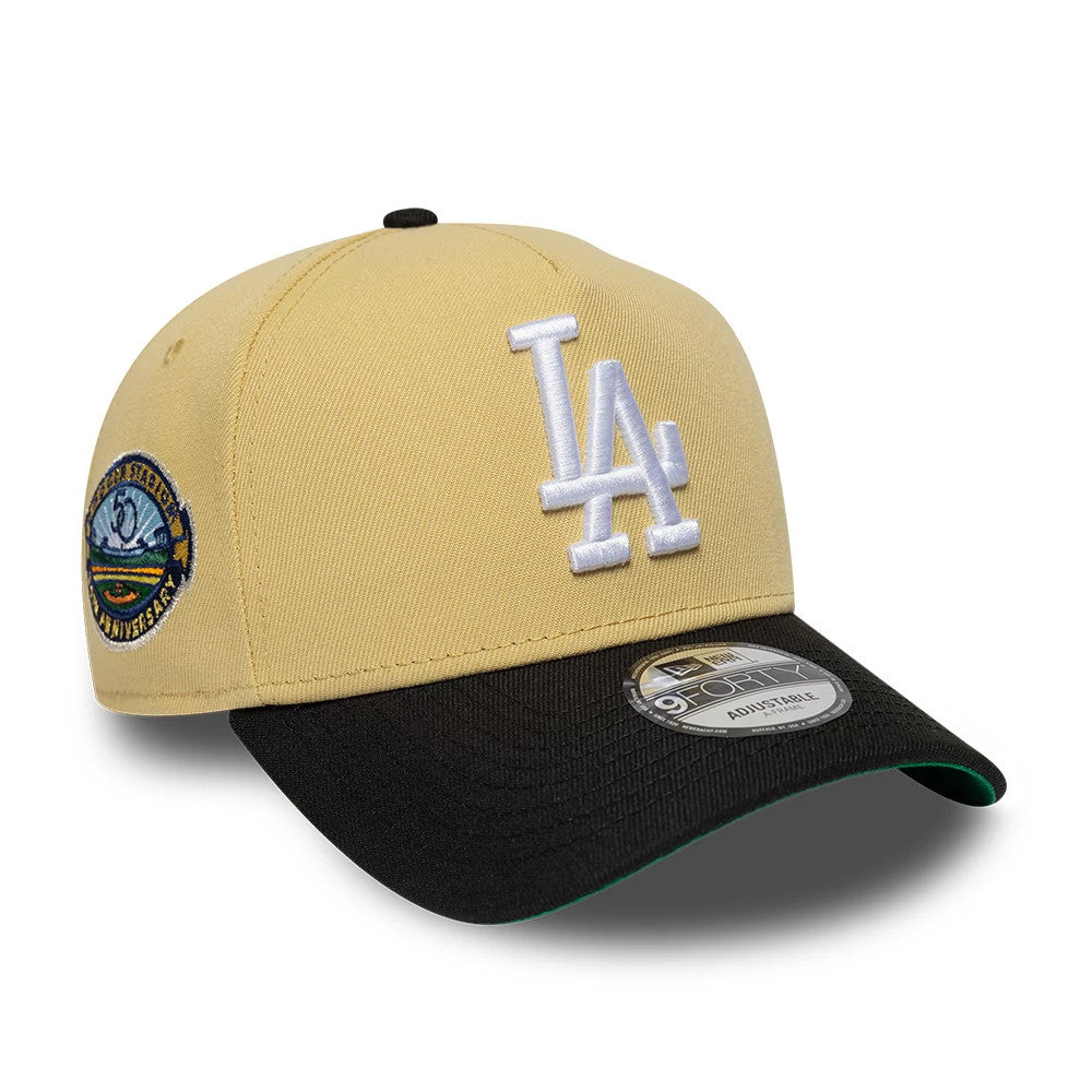 LA Dodgers MLB Vegas Gold New Era 9FORTY A-Frame Cap, three-quarter view showing the white raised embroidered LA logo on the vegas gold crown, a black curved visor with 9FORTY size sticker, and a special logo patch on the left side.