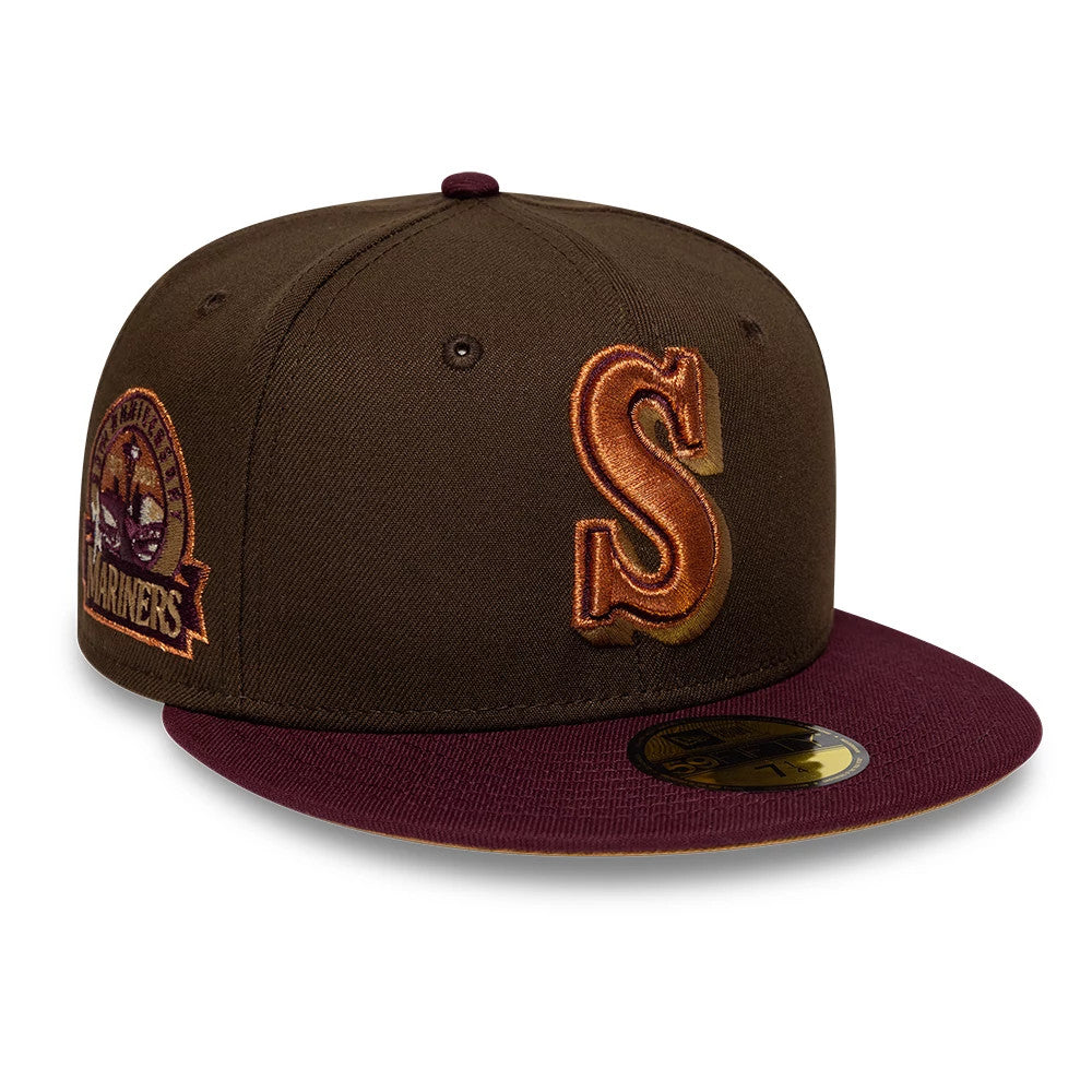 Seattle Mariners MLB Cooperstown Dark Brown New Era 59FIFTY Fitted Cap, front view showing a raised brown and orange embroidered S on the front panel, with a maroon visor and a dark brown cap, featuring a size sticker on the visor.