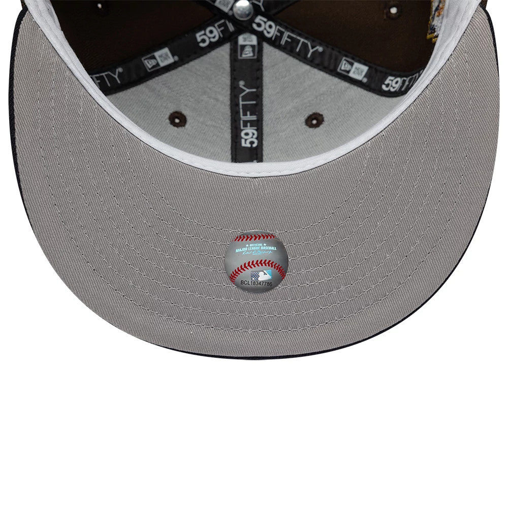 Cleveland Guardians MLB Cooperstown Dark Brown & Navy New Era 59FIFTY Fitted Cap, inside view showing the grey undervisor with an MLB baseball sticker, black 59FIFTY branded taping along the seams, and a grey sweatband contrasted by dark eyelets.