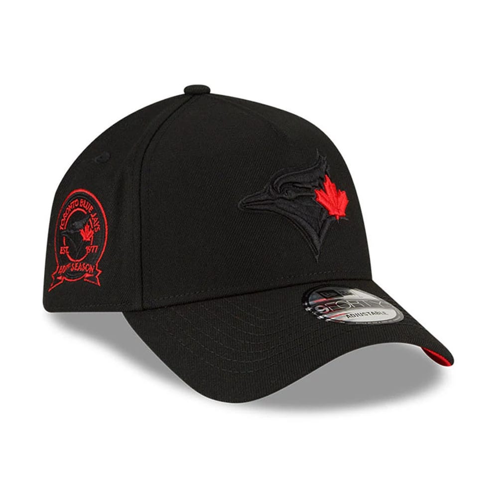 Toronto Blue Jays MLB Cooperstown Black New Era 9FORTY A-Frame Cap, three-quarter view showing the black and red embroidered Blue Jays logo on the front panel, curved visor with a 9FORTY size sticker, and red embroidered side patch.