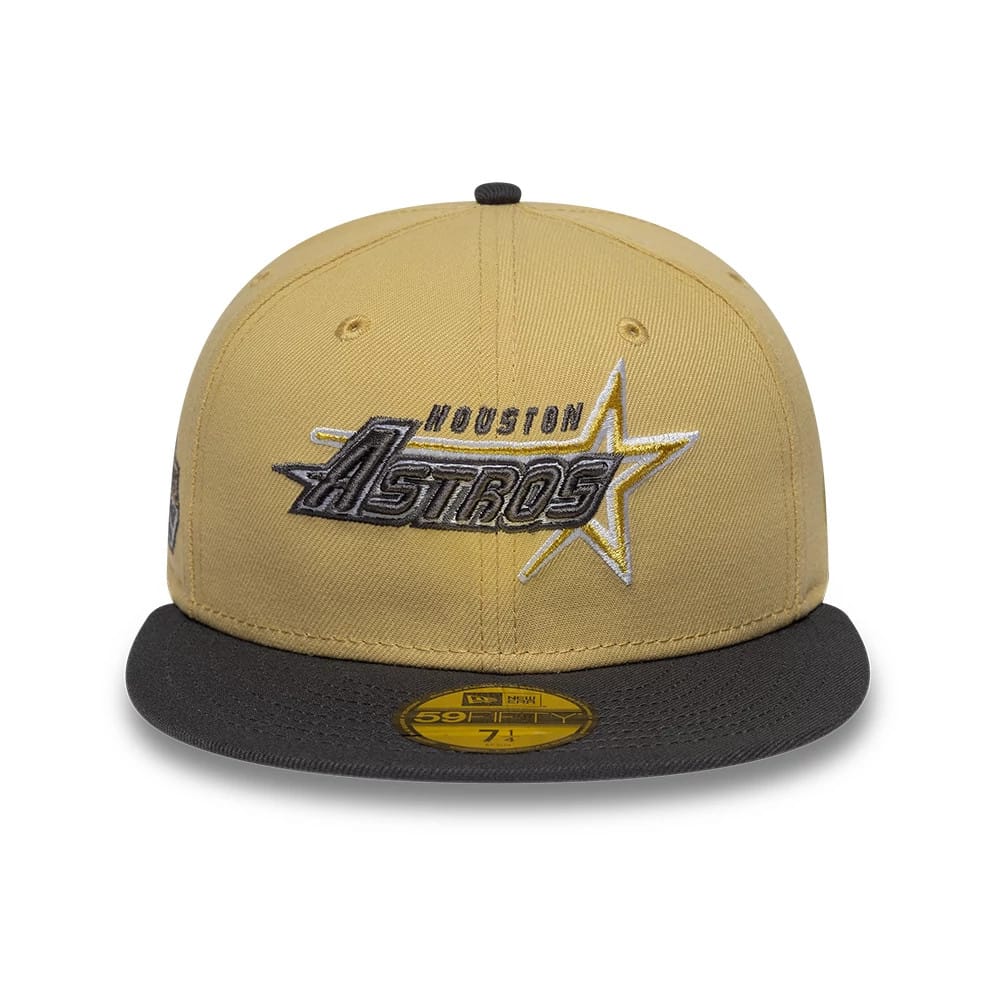Houston Astros MLB Vegas Gold New Era 59FIFTY Fitted Cap, front view showing the team's logo with raised embroidery in grey and white on the vegas gold crown, complemented by a black flat visor and a gold 59FIFTY size sticker on it.