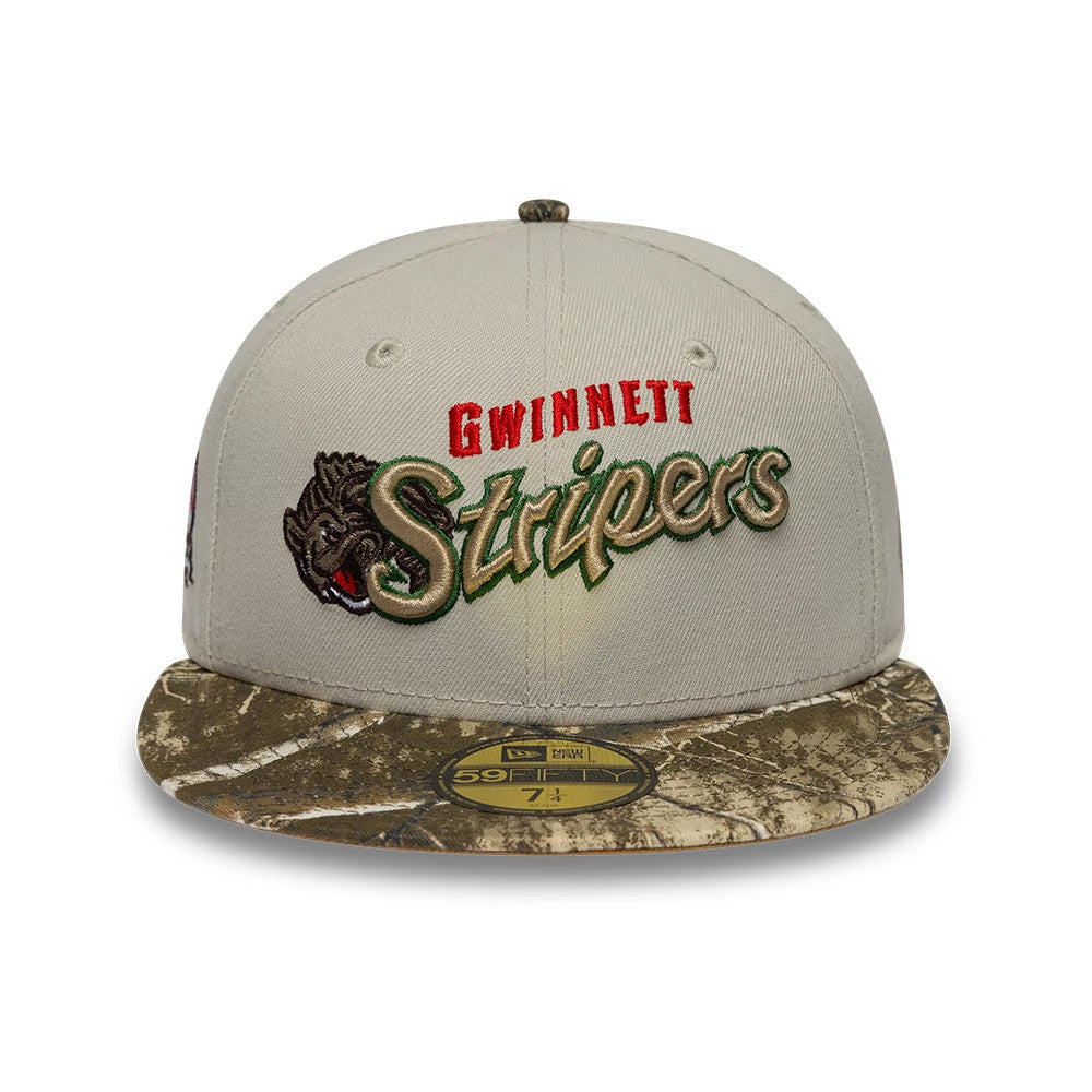 Gwinnett Stripers MiLB Hometown Sidepatch Beige New Era 59FIFTY Fitted Cap, front view showing the raised team logo embroidery with red and green accents on the beige crown, a camo-patterned visor, and a gold 59FIFTY size sticker.