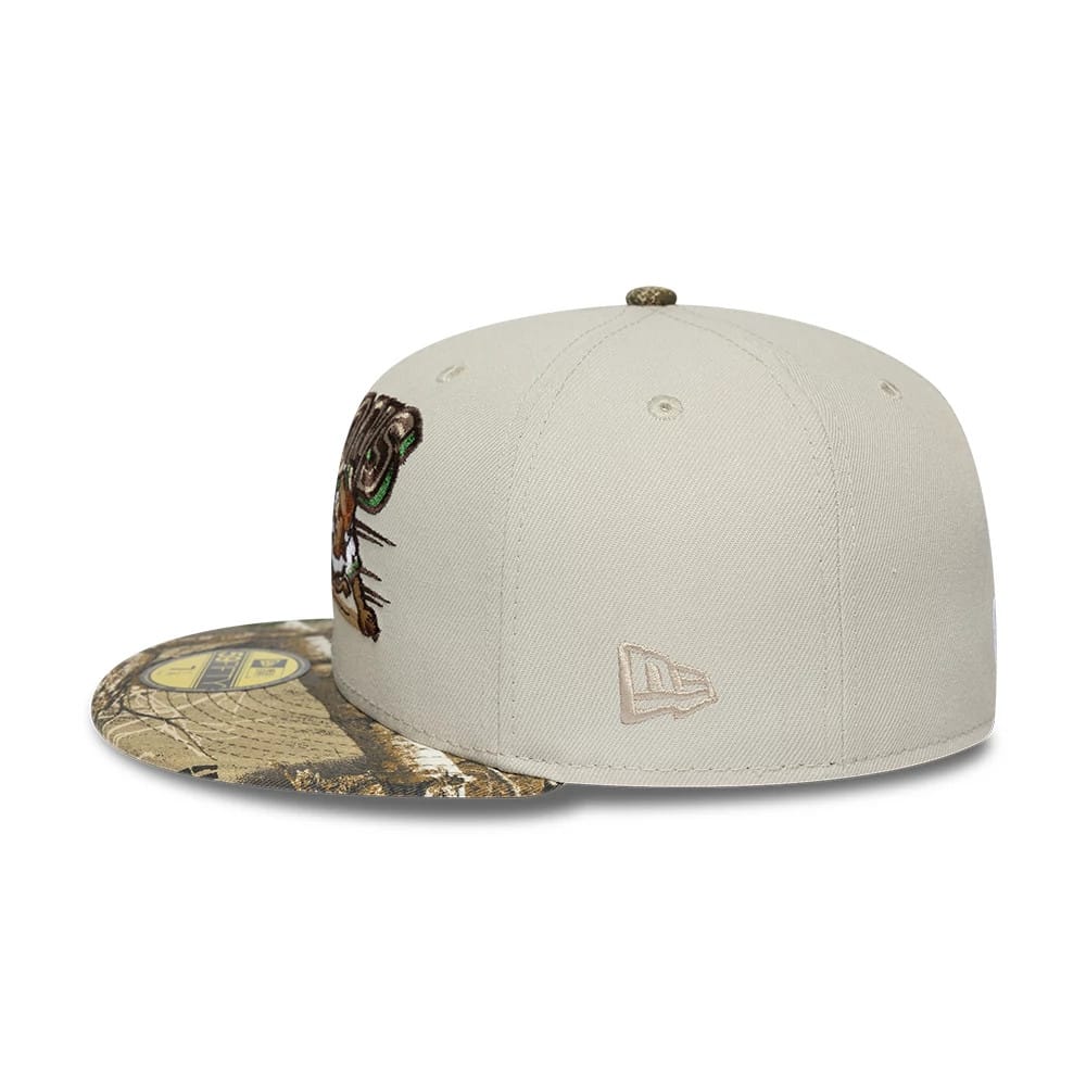 Buffalo Bisons MiLB Hometown Beige New Era 59FIFTY Fitted Cap, side view showing the embroidered New Era flag logo on the left side, a camo-patterned flat visor with a 59FIFTY size sticker, and a multicoloured team logo on the front panel.