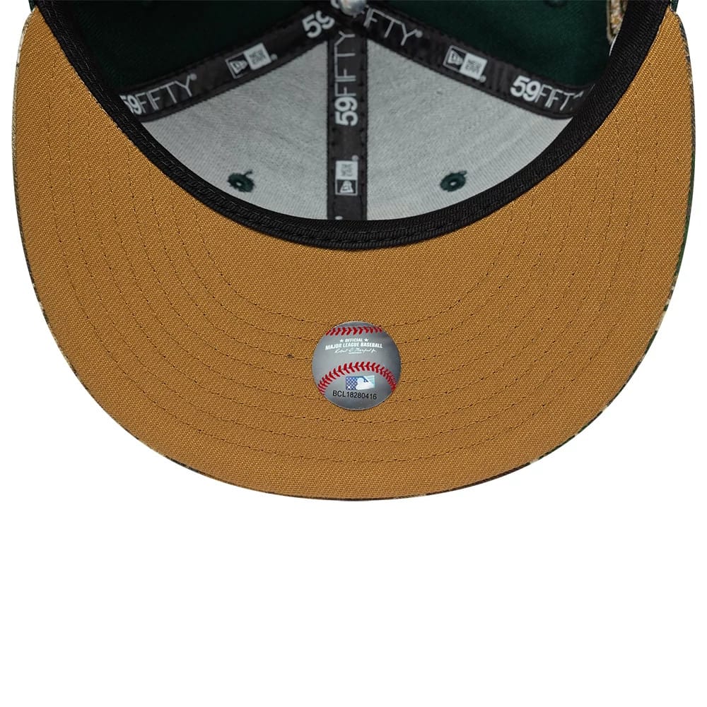 Houston Astros MLB Cooperstown Green New Era 59FIFTY Fitted Cap, inside view showing the grey undervisor featuring a small baseball graphic decal, black internal taping with repeated 59FIFTY branding.
