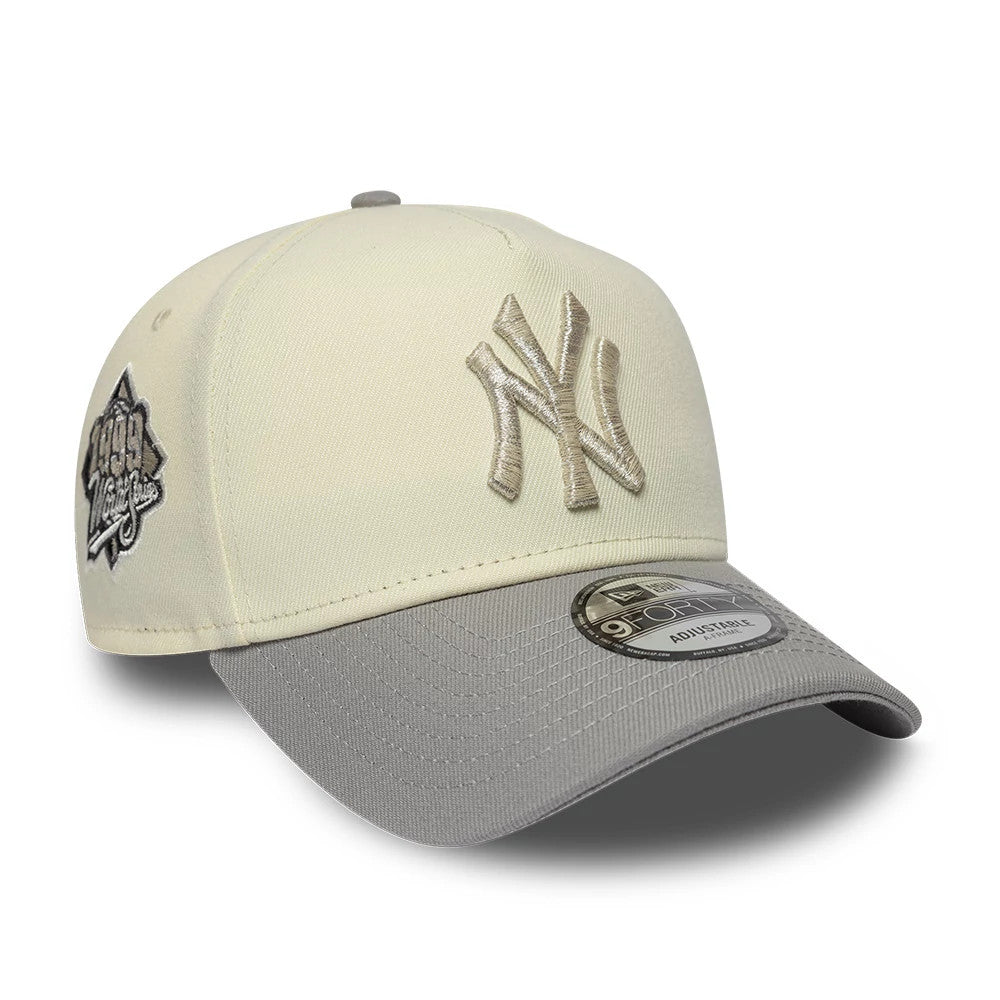 New York Yankees MLB Cooperstown White & Grey New Era 9FORTY A-Frame Cap, three-quarter view showing the raised beige embroidered NY logo on the white front panel, grey curved visor with a 9FORTY size sticker, and commemorative side patch.