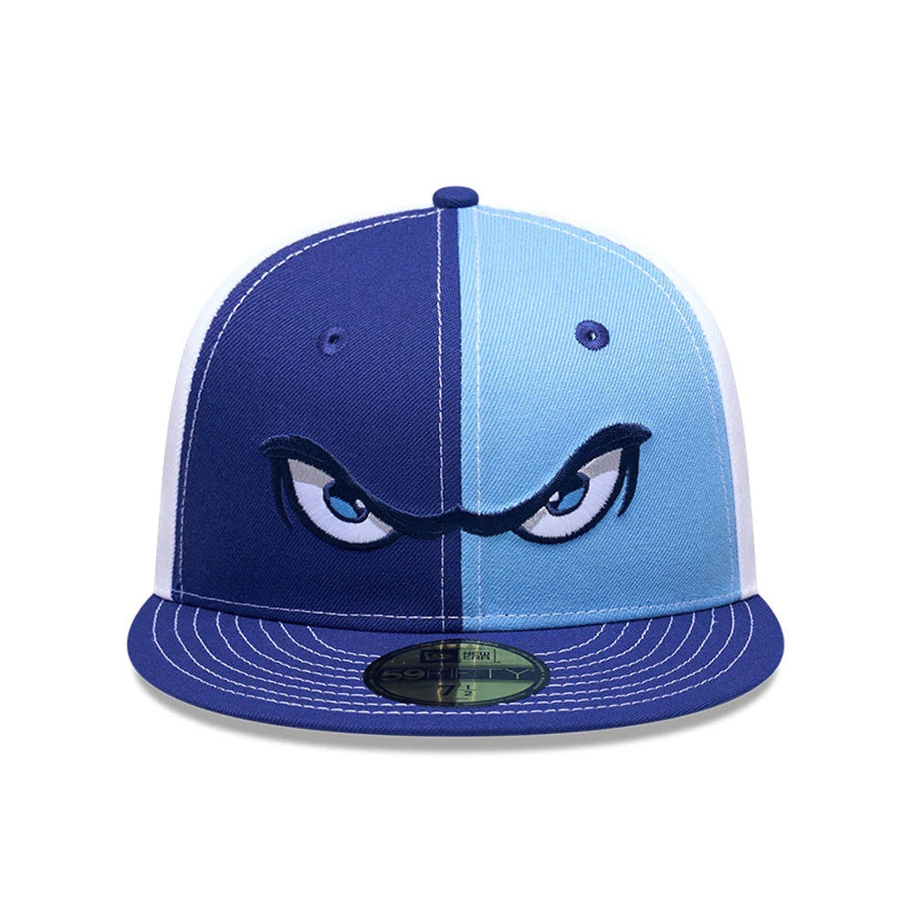 Lake Elsinore Storm MiLB Pinwheel Pastel Blue New Era 59FIFTY Fitted Cap, front view showing the embroidered angry eyes logo on the central panel, with a pinwheel colour design, flat navy visor, and a gold 59FIFTY size sticker.