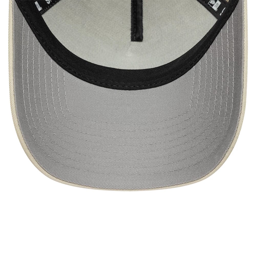 New Era Beige 9FORTY A-Frame Adjustable Cap, inside view showing a light grey undervisor with contrasting black edge trim, complemented by high-quality taping along the seam and a soft fabric sweatband for added comfort during wear.