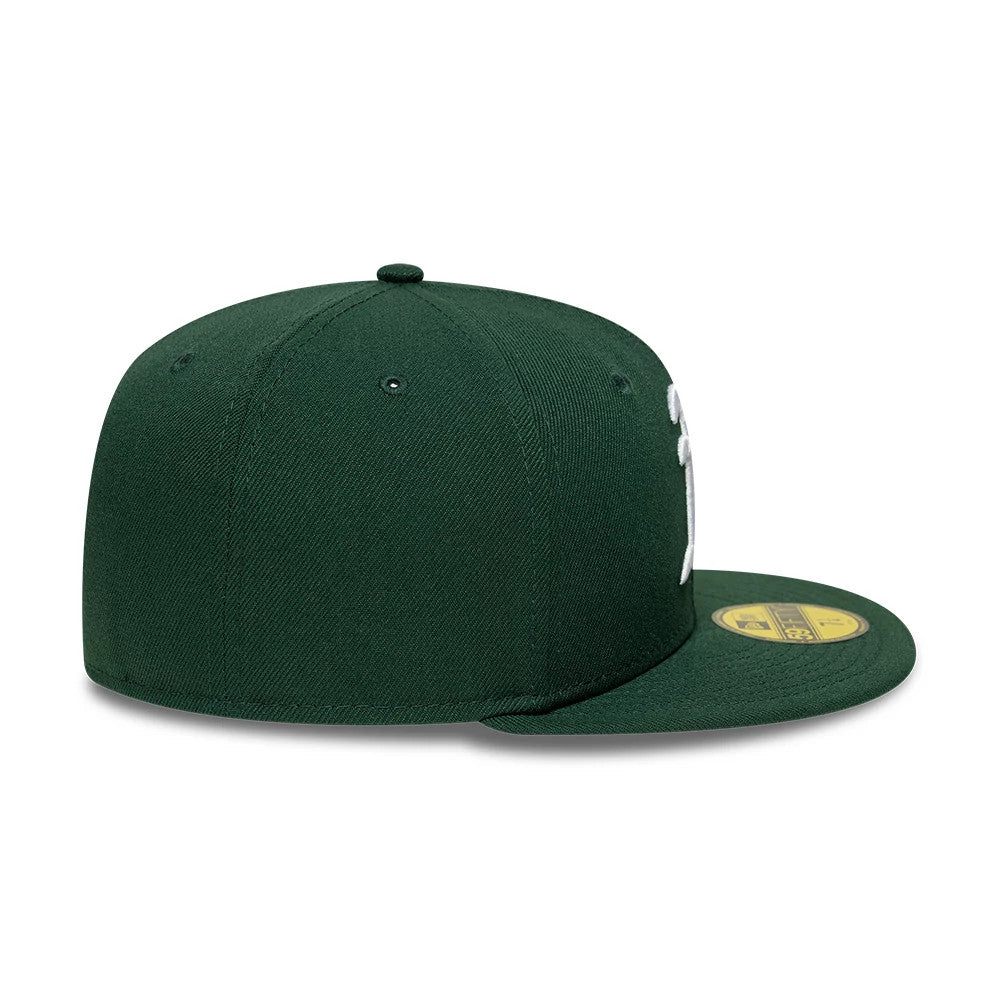 Athletics MLB Dark Green New Era 59FIFTY Fitted Cap, side view showing the white embroidered logo on the front panel, a structured dark green crown with matching eyelets, and the gold 59FIFTY size sticker on the flat dark green visor.
