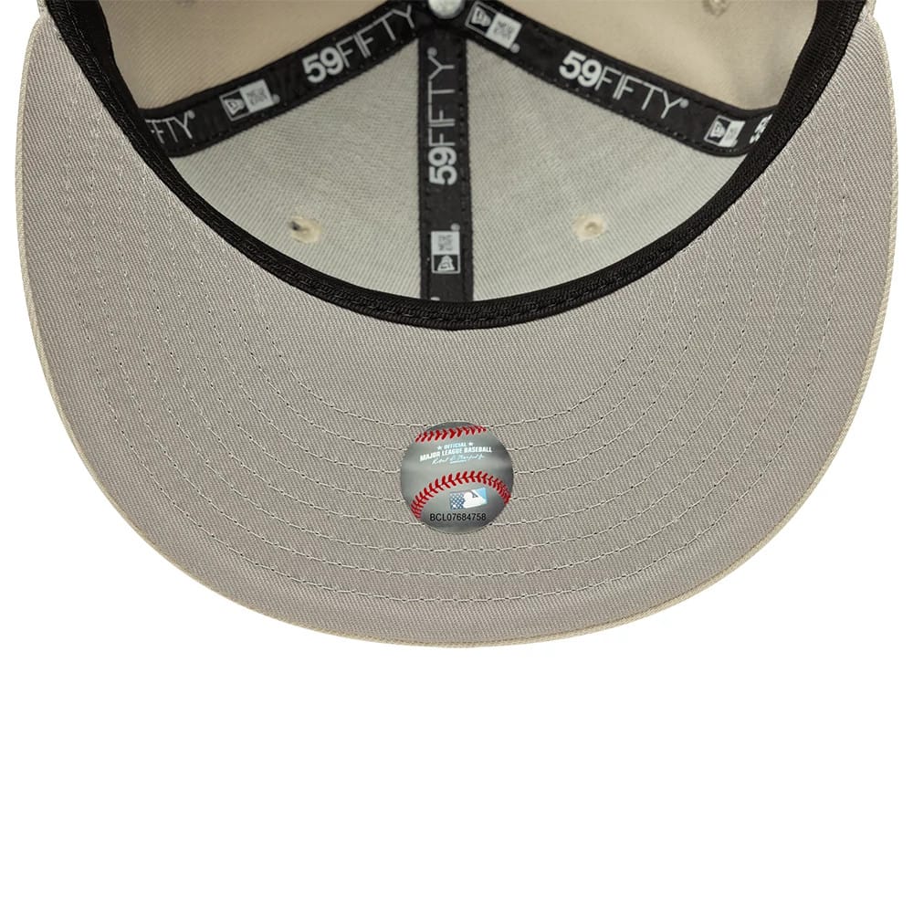 LA Dodgers MLB Beige New Era 59FIFTY Fitted Cap, inside view showing the contrasting black sweatband with branded 59FIFTY taping, beige undervisor with a Major League Baseball sticker in the centre, and matching beige stitching.