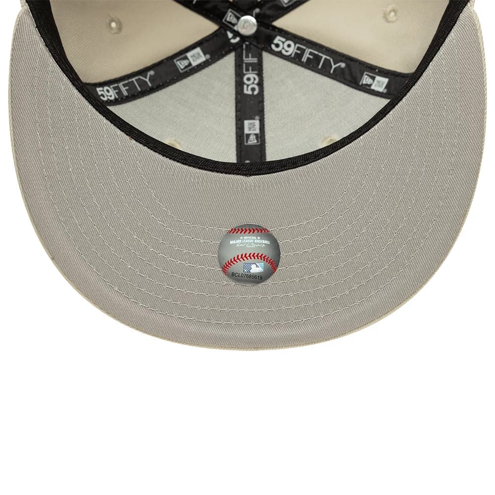 Detroit Tigers MLB Beige New Era 59FIFTY Fitted Cap, inside view showing the black sweatband with white 59FIFTY and New Era logos, a grey undervisor, and a baseball-themed sticker placed at the centre of the beige visor.