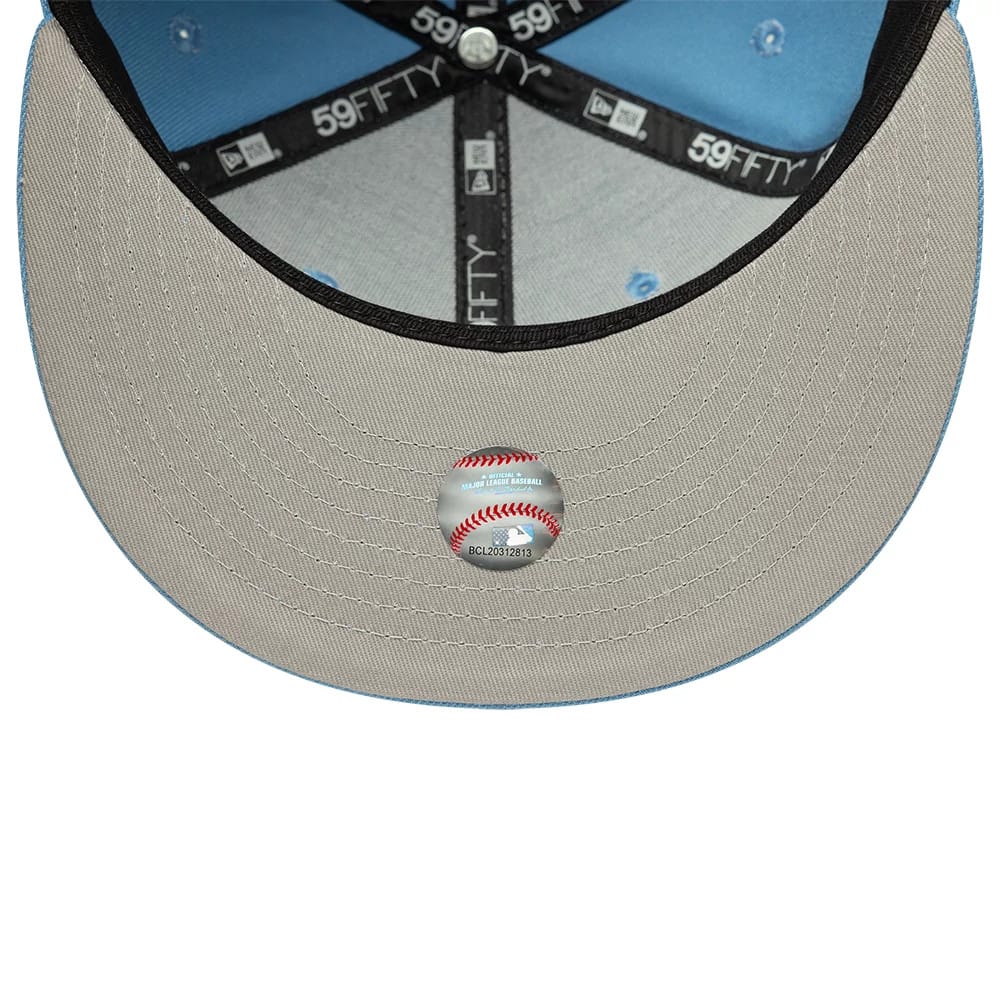 Atlanta Braves MLB Pastel Blue New Era 59FIFTY Fitted Cap, inside view showing the grey undervisor with a round baseball-themed sticker, black 59FIFTY branded taping on the seams, and a light blue interior crown.