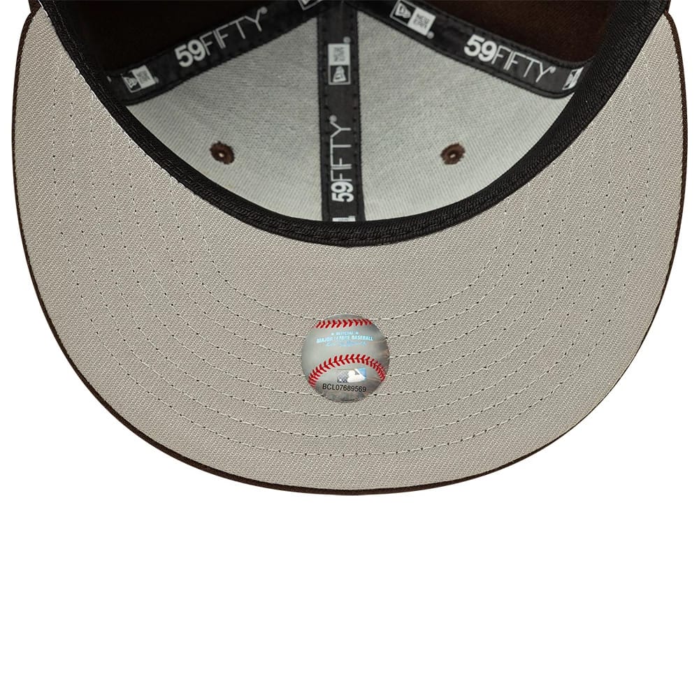 Chicago White Sox MLB Dark Brown New Era 59FIFTY Fitted Cap, inside view showing the grey undervisor with a baseball-themed sticker, black 59FIFTY taping along the seams, and the contrasting grey sweatband lining the interior.