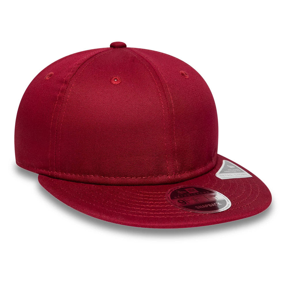 New Era Red Retro Crown 9FIFTY Snapback Adjustable Cap, three-quarter view showing the curved red visor with a 9FIFTY size sticker, embroidered top button and eyelets, and a structured red crown.
