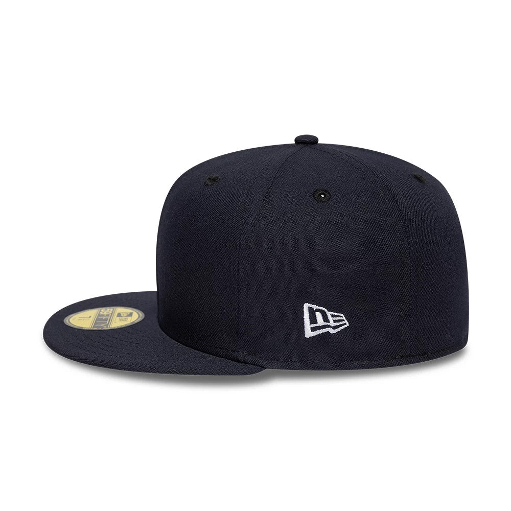 New Era Navy 59FIFTY Fitted Cap, side view showing the white embroidered New Era flag logo on the left side of the structured navy crown, with a flat visor featuring a gold 59FIFTY size sticker and matching eyelets.