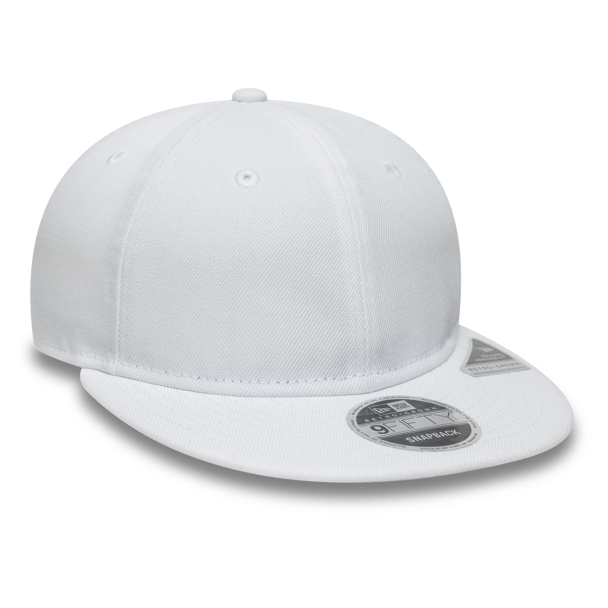 New Era White Retro Crown 9FIFTY Snapback Adjustable Cap, three-quarter view showing a white structured crown with matching white visor and top button, featuring a silver 9FIFTY size sticker on the visor and centred eyelets.
