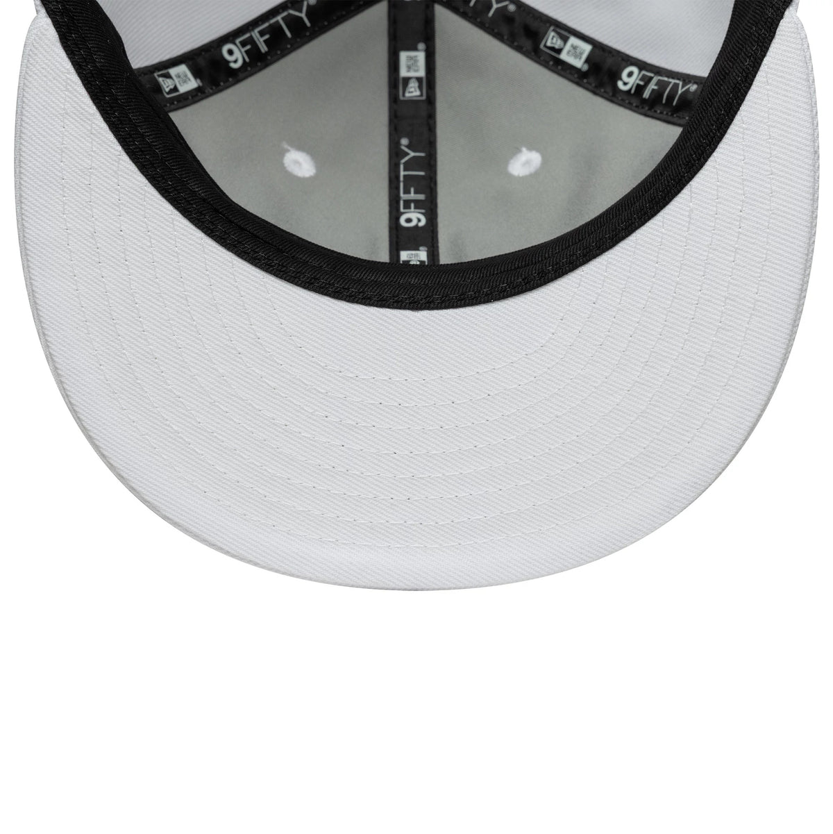 New Era White Retro Crown 9FIFTY Snapback Adjustable Cap, inside view showing a white undervisor with black taping featuring the 9FIFTY logo along the seams, complemented by black stitching details and eight reinforced eyelets on the grey crown.
