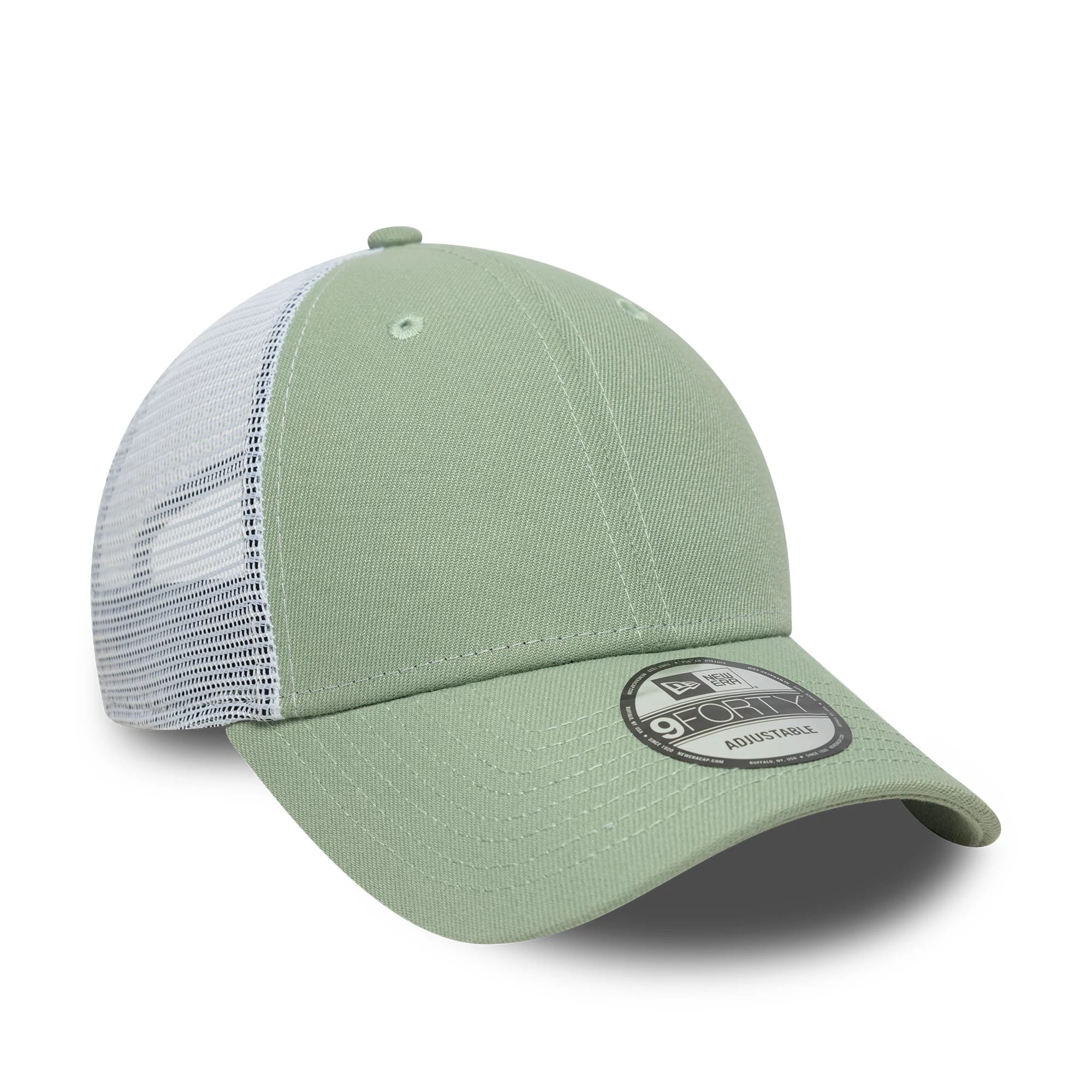 New Era Green 9FORTY Trucker Adjustable Cap, three-quarter view showing the black and white 9FORTY size sticker on the pale green curved visor, light green front panel with two eyelets, and white mesh back panels.