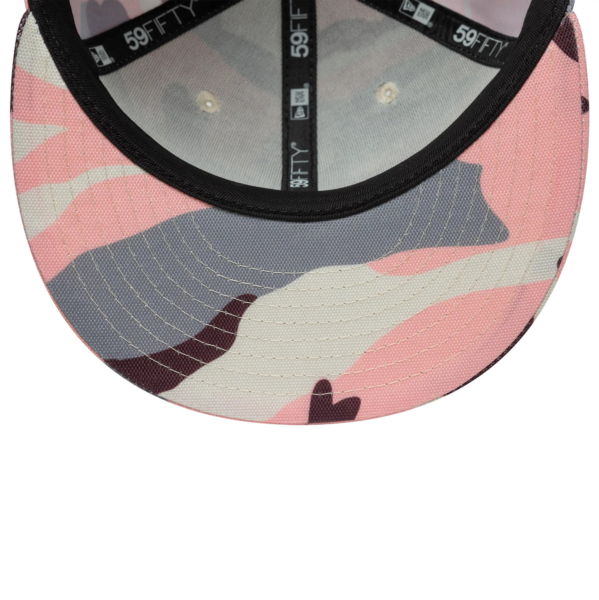 New Era Pink Camo 59FIFTY Fitted Cap, inside view showing a camouflage pattern on the undervisor, black interior taping with white 59FIFTY branding, and a grey sweatband that lines the structured crown.