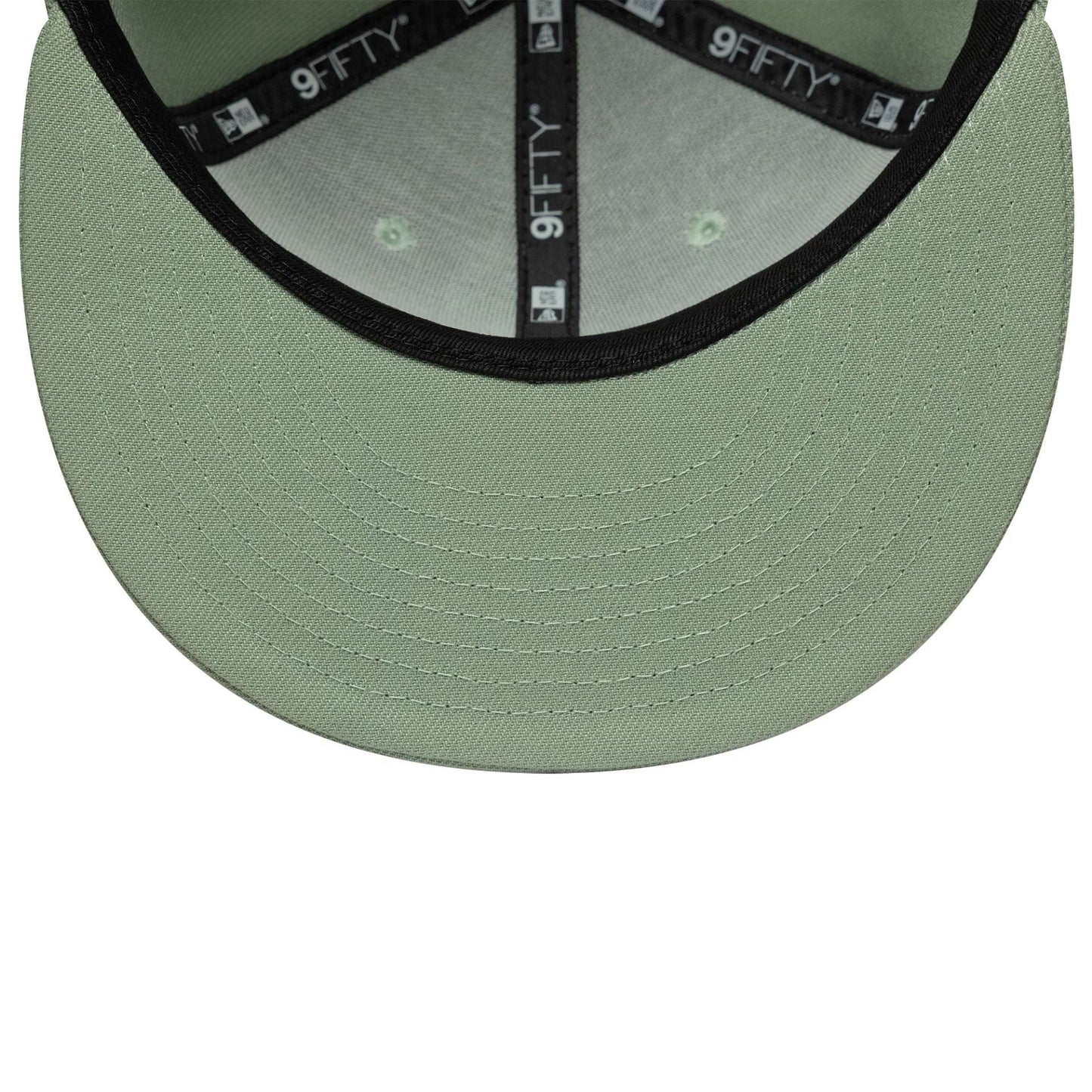 New Era Green 9FIFTY Snapback Adjustable Cap, inside view showing the black 9FIFTY taping along the seams, light green undervisor with detailed stitching, and matching fabric panels with a green tone under each eyelet for a cohesive look.
