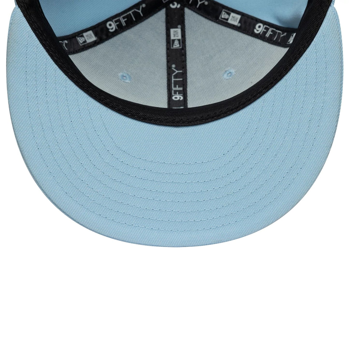 New Era Blue 9FIFTY Snapback Adjustable Cap, inside view showing the light blue undervisor, black sweatband, and branded 9FIFTY taping across the structured crown, with blue eyelets on the interior panels.