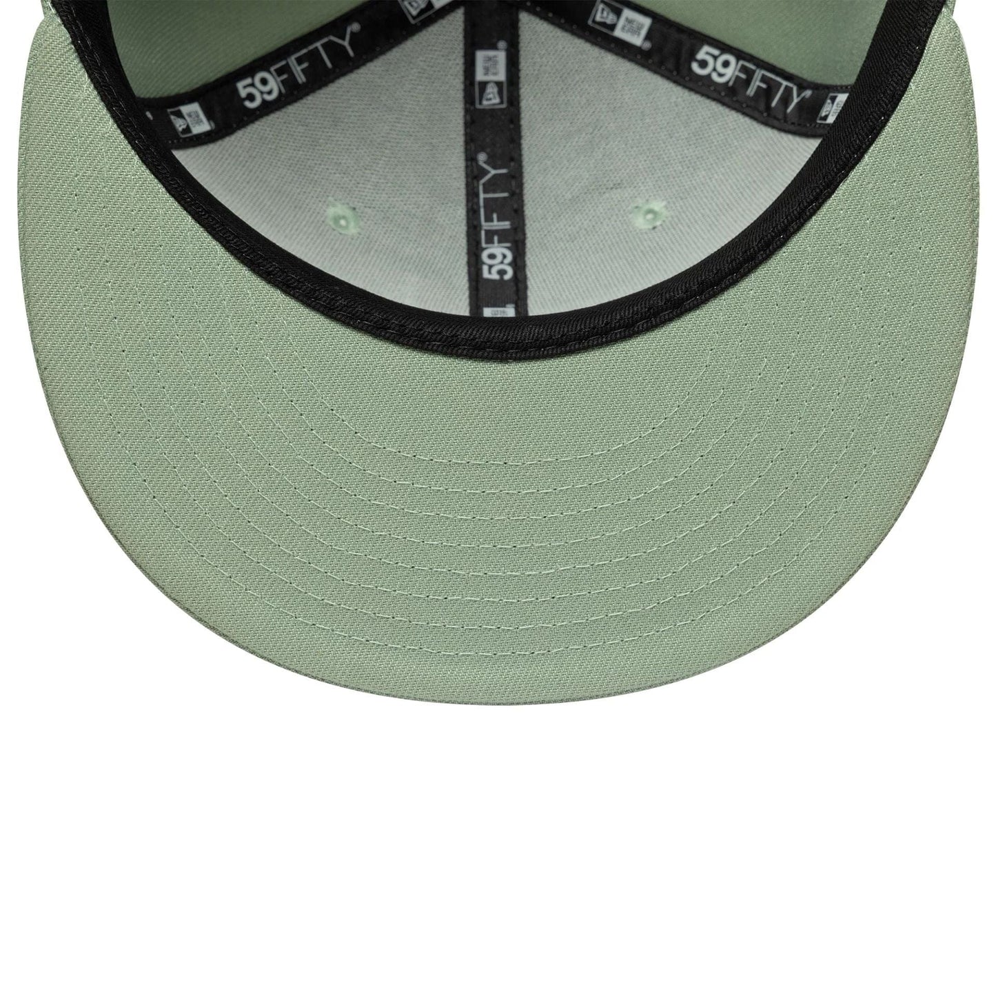 New Era Green 59FIFTY Fitted Cap, inside view showing a pale green undervisor with black stitching, black 59FIFTY taping along the seams, and a black sweatband, highlighting the structured fit and quality details.