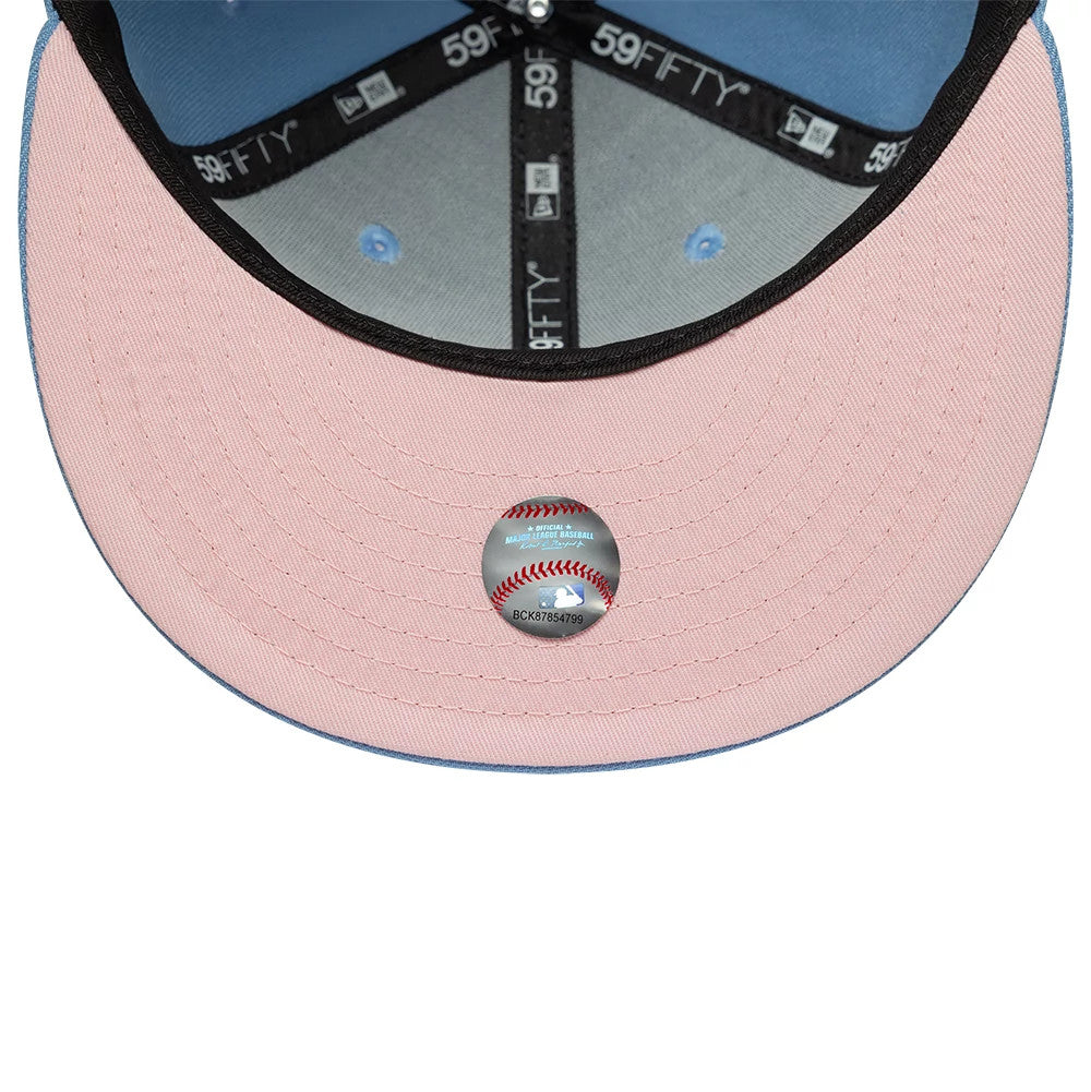 New York Yankees MLB Pastel Blue New Era 59FIFTY Fitted Cap, inside view showing pink undervisor with an MLB size sticker, blue taping with repeating white 59FIFTY logos, and light blue interior panels with matching eyelets.