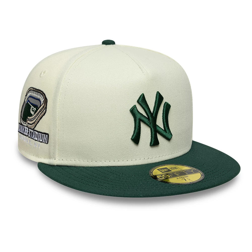 New York Yankees MLB Cream New Era 59FIFTY A-Frame Fitted Cap, three-quarter view showing the dark green raised embroidered NY logo on the front panel, green flat visor, and gold 59FIFTY size sticker, with a Yankees Stadium patch on the left side.