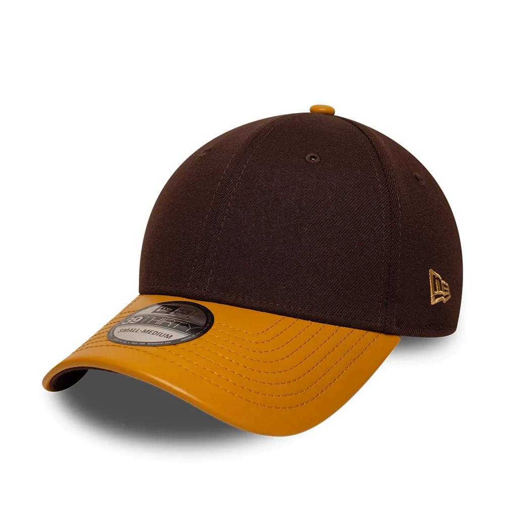 New Era Dark Brown 39THIRTY Stretch Fit Cap, three-quarter view showing the raised brown embroidered New Era flag logo on the left side, a contrasting gold curved visor with 39THIRTY size sticker, and a matching gold top button.