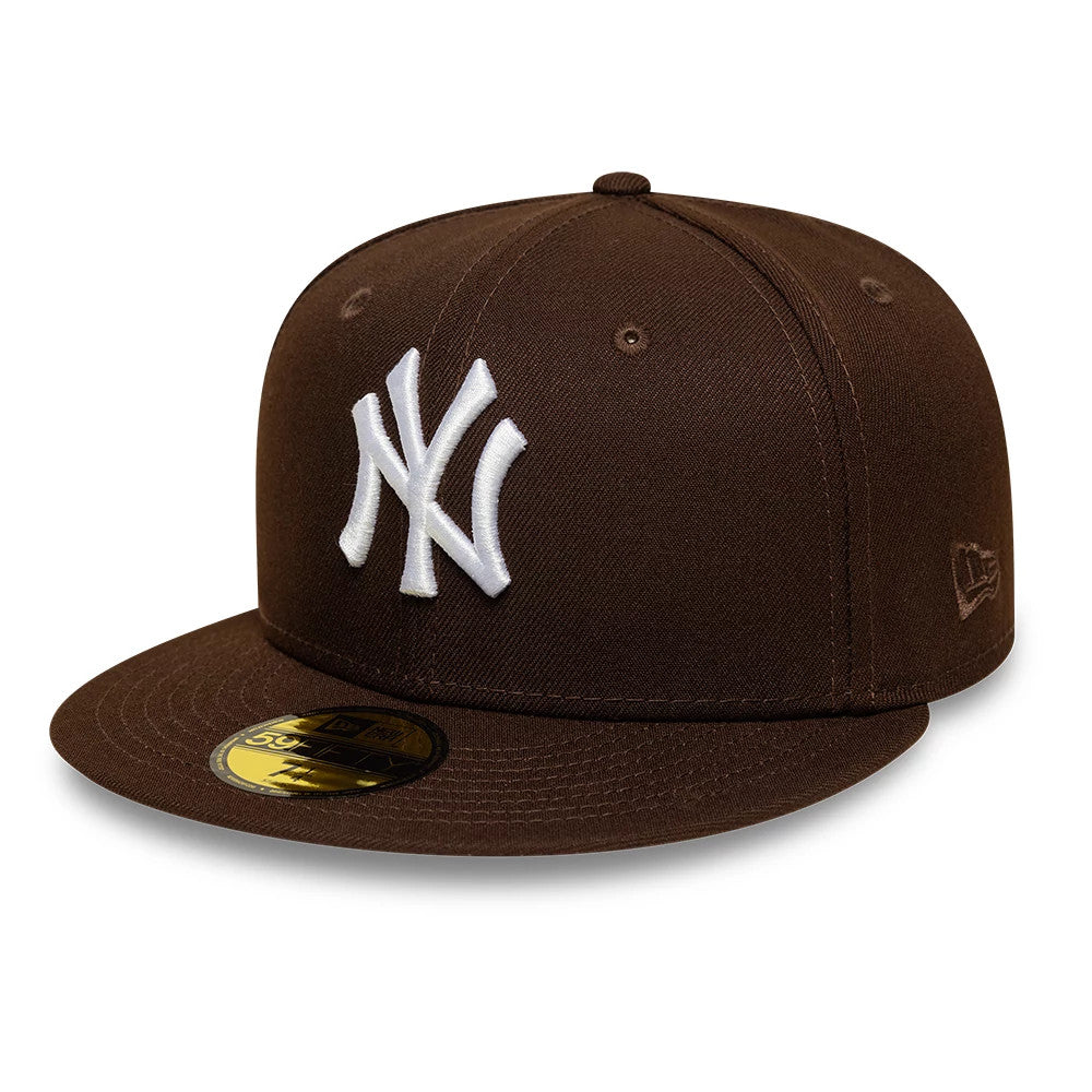 New York Yankees MLB Dark Brown New Era 59FIFTY Fitted Cap, three-quarter view showing the white raised embroidered NY logo on the front panel, matching dark brown flat visor with a gold 59FIFTY size sticker.