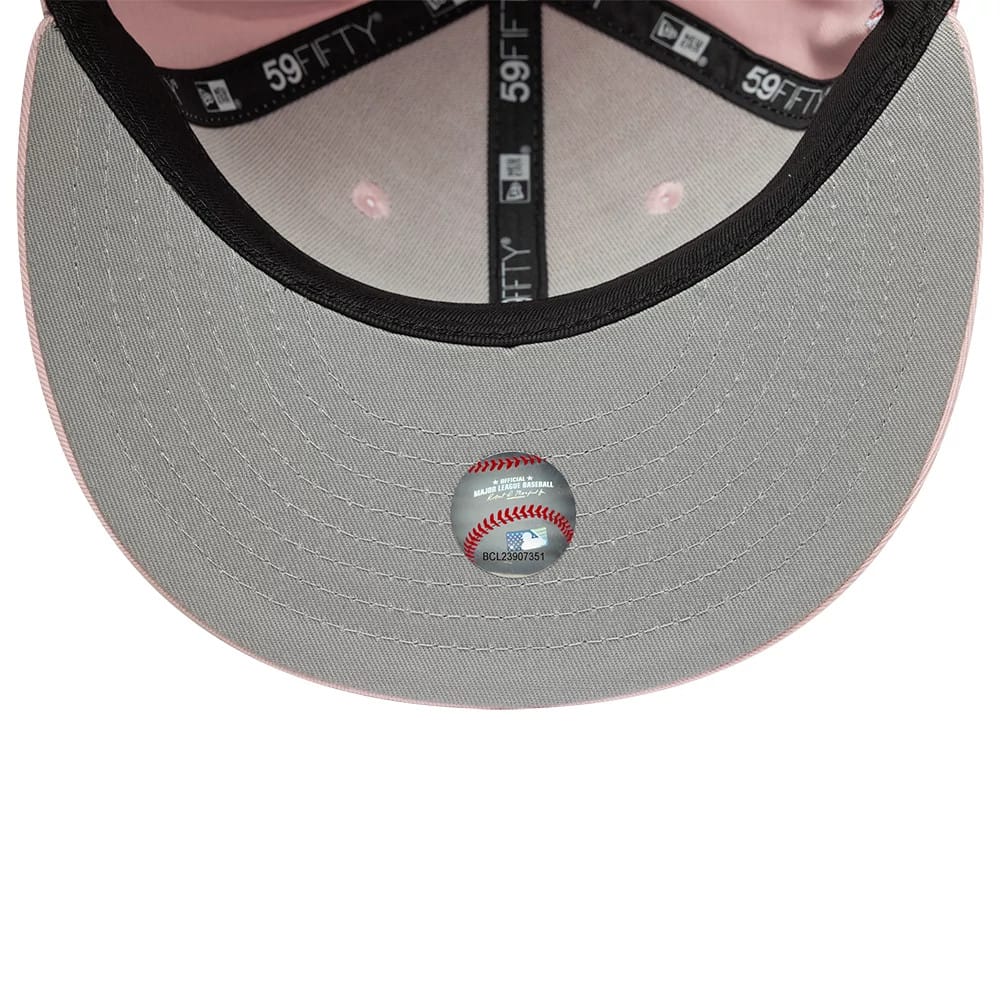 LA Dodgers MLB Pink New Era 59FIFTY Fitted Cap, inside view showing black 59FIFTY taping, a grey undervisor with a baseball sticker in the centre, and light pink interior panels with matching eyelets.