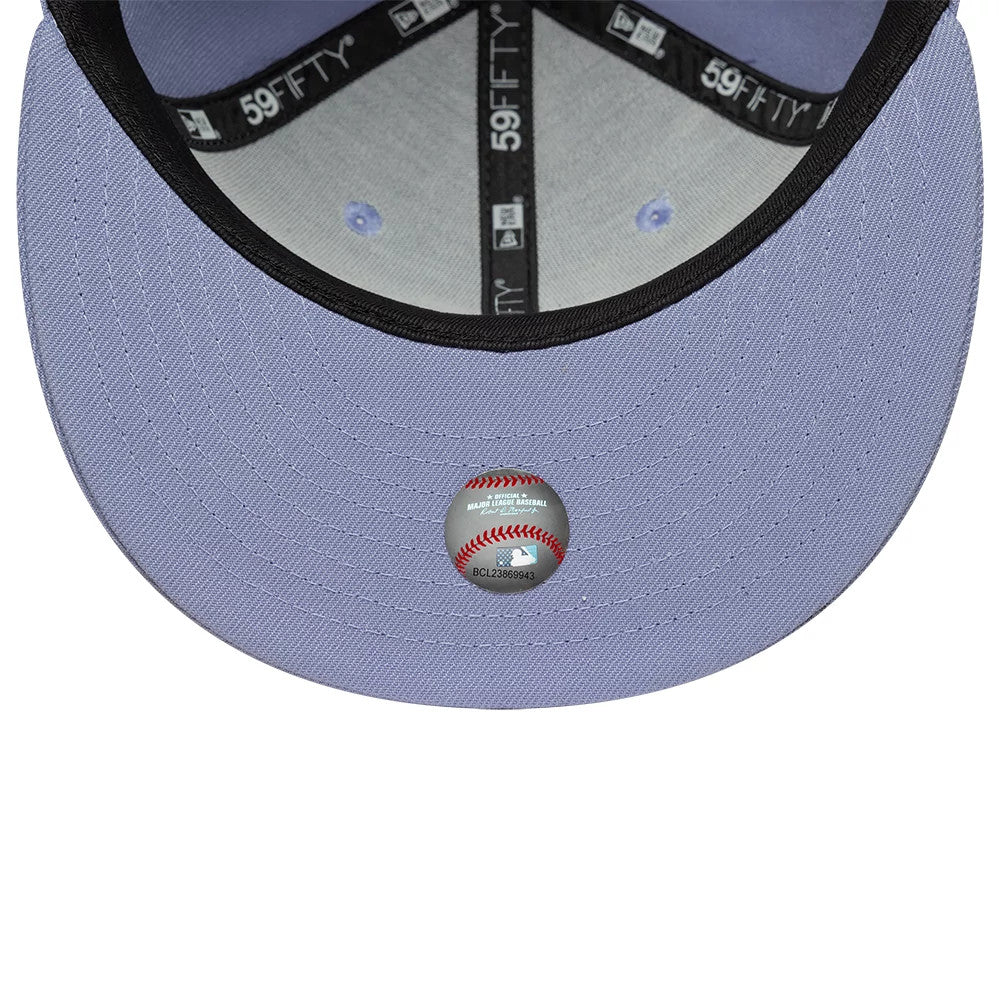 Atlanta Braves MLB Pastel Purple New Era 59FIFTY Fitted Cap, inside view showing the grey undervisor and black taping with 59FIFTY branding, along with a round holographic sticker featuring a baseball design in the centre.