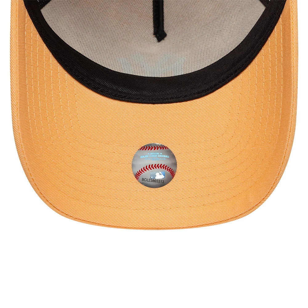 New York Yankees MLB Pastel Orange New Era 9FORTY A-Frame Adjustable Cap, inside view showing the light orange undervisor with a white mesh sweatband, a black trim, and an MLB holographic sticker at the centre.
