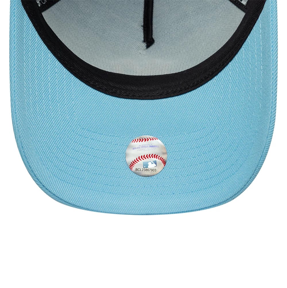 New York Yankees MLB Pastel Blue New Era 9FORTY A-Frame Adjustable Cap, inside view showing black taping along the seams, a grey sweatband, and a Major League Baseball holographic sticker on the light blue undervisor.