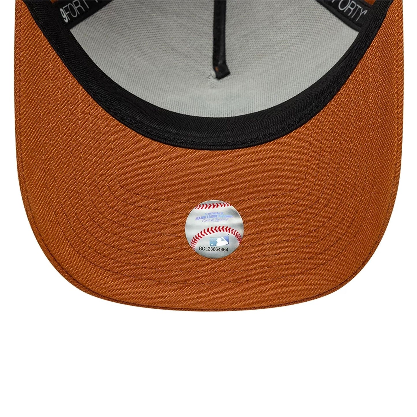 New York Yankees MLB Brown New Era 9FORTY A-Frame Adjustable Cap, inside view showing the grey undervisor contrasting with the brown visor, black taped seams along the structured interior, and a circular sticker with a baseball design.