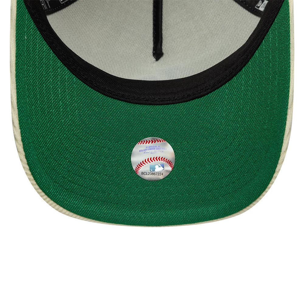 LA Dodgers MLB Cord Cream New Era 9FORTY A-Frame Adjustable Cap, inside view showing the green undervisor with an MLB sticker in the shape of a baseball, along with black taping and a grey sweatband lining the interior.